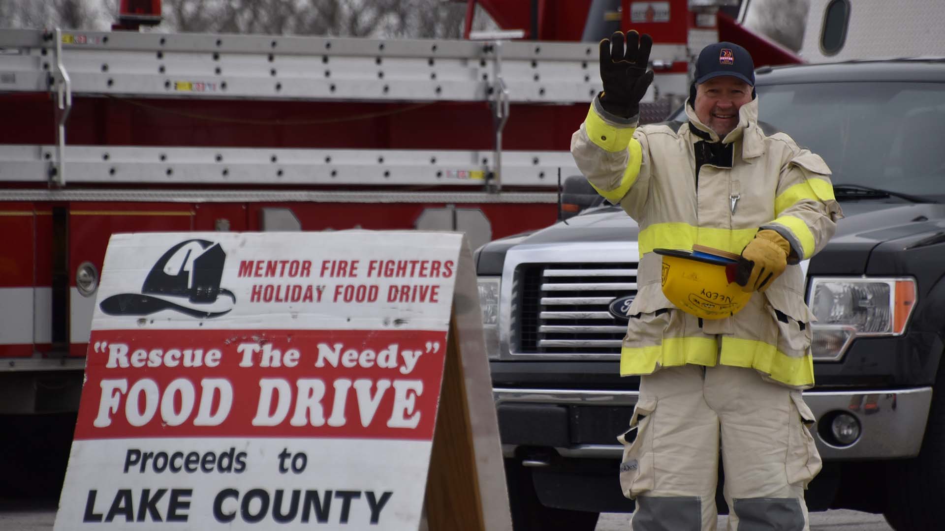 Image of volunteer collecting donations at Mentor Fire Rescue the Needy Food Drive.