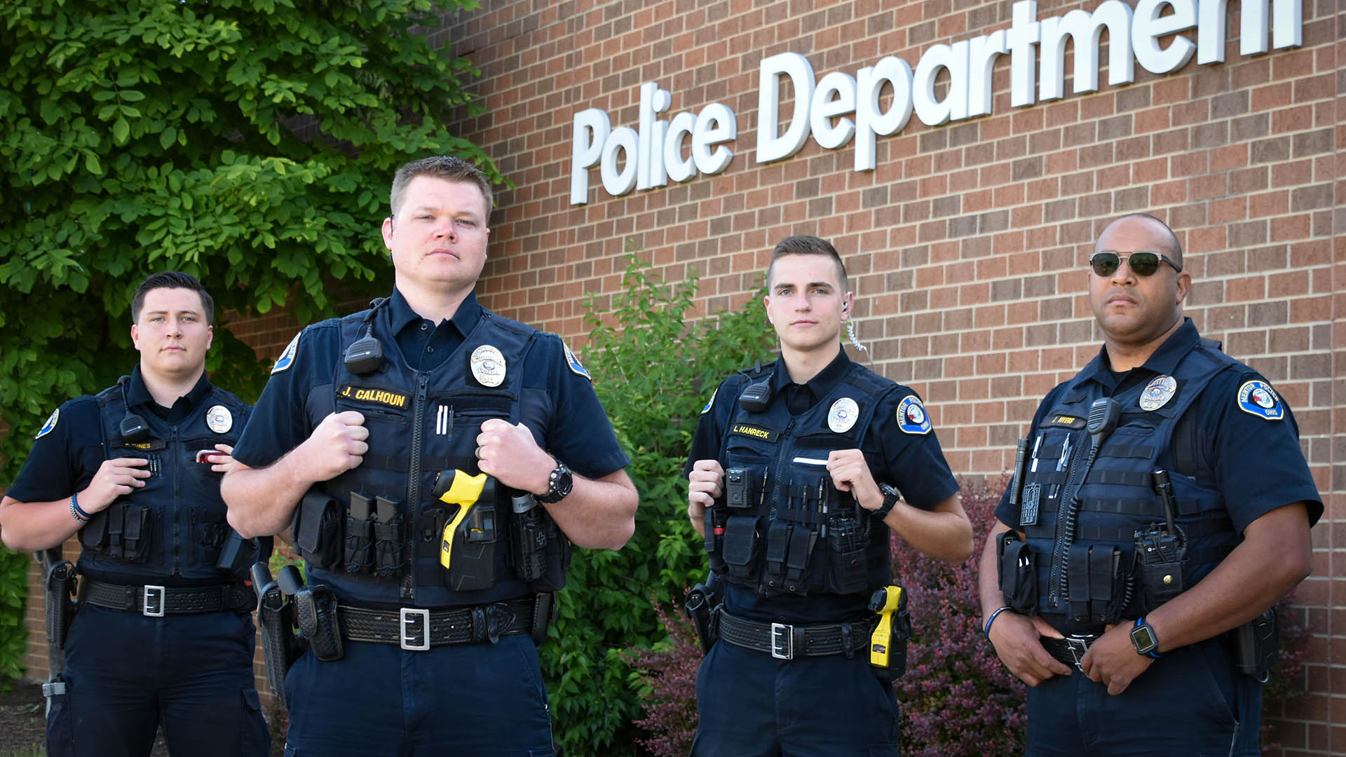 A group of Mentor police officers standing in front of the Mentor Police Station.