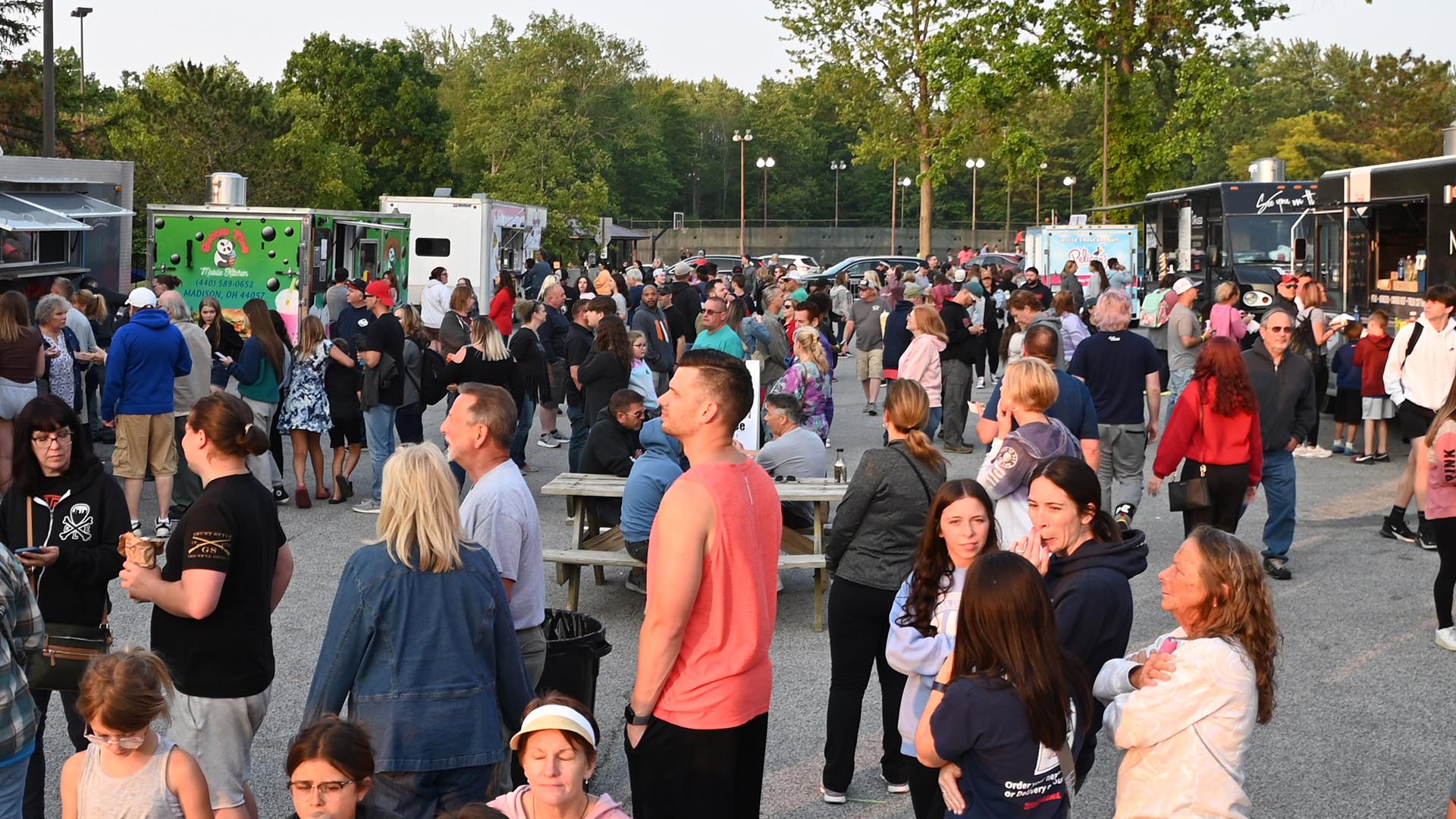 A crowd of people in the food vendor area at a Mentor Rocks concert.